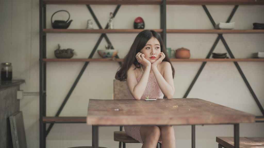 Banner of Woman looking Bored at a Table