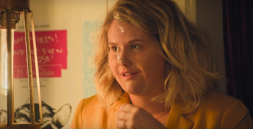 Brittany at work goofing off. Woman with tape on her nose making it look like a pig's snout.