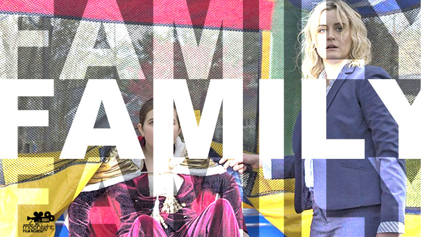 Woman and girl near a bouncy castle.