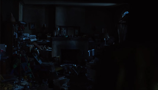 Screenshot of the dead painter's apartment. Messy apartment with books, papers and paint everywhere.