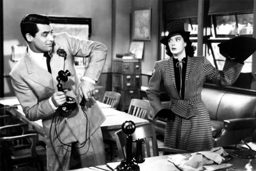 Screenshot of His Girls Friday (1940) a purse is about to be thrown at Cary Grant by his ex-wife at the newspaper office while holding a 1920's telephone.